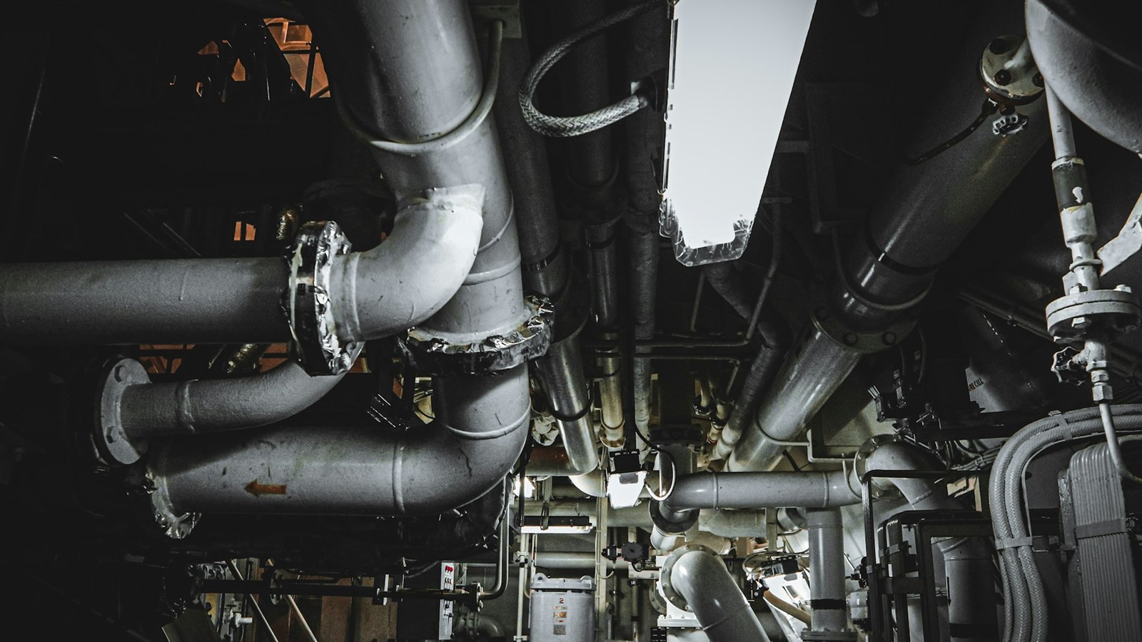 Bilge and service pipework in a ship engine room