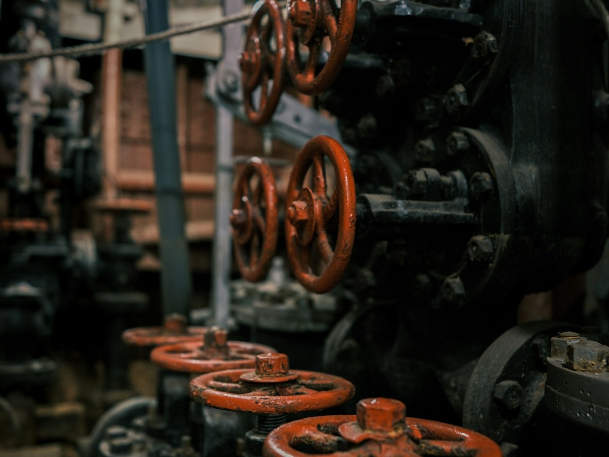 Handwheel-operated valves on an engine room pipe run