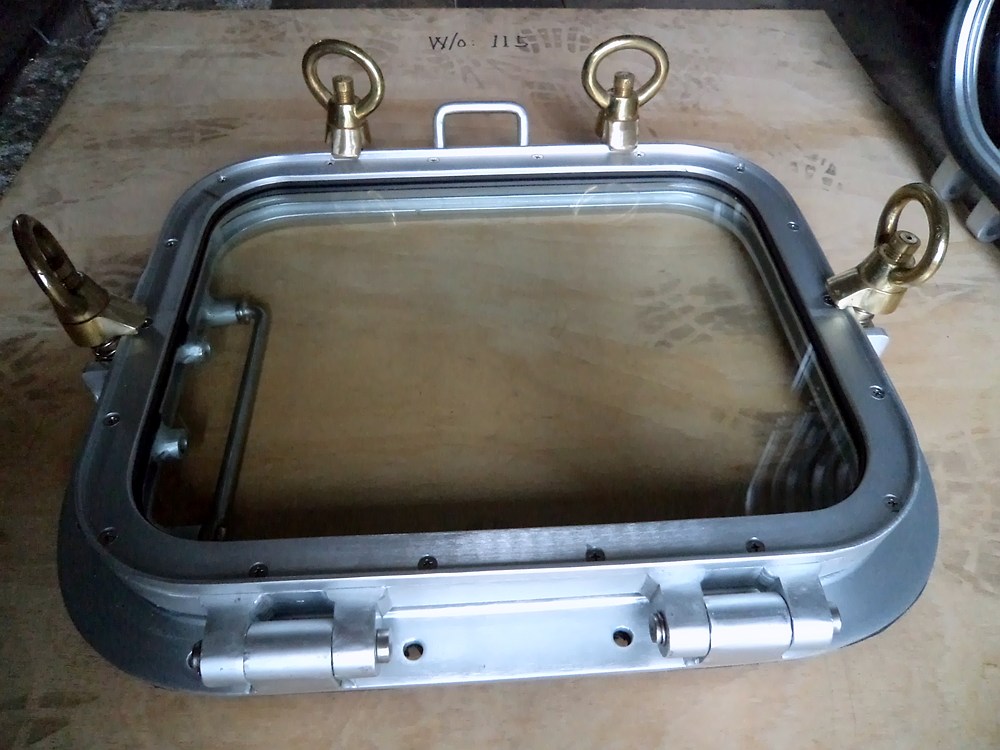 Aluminium window frame with brass fittings